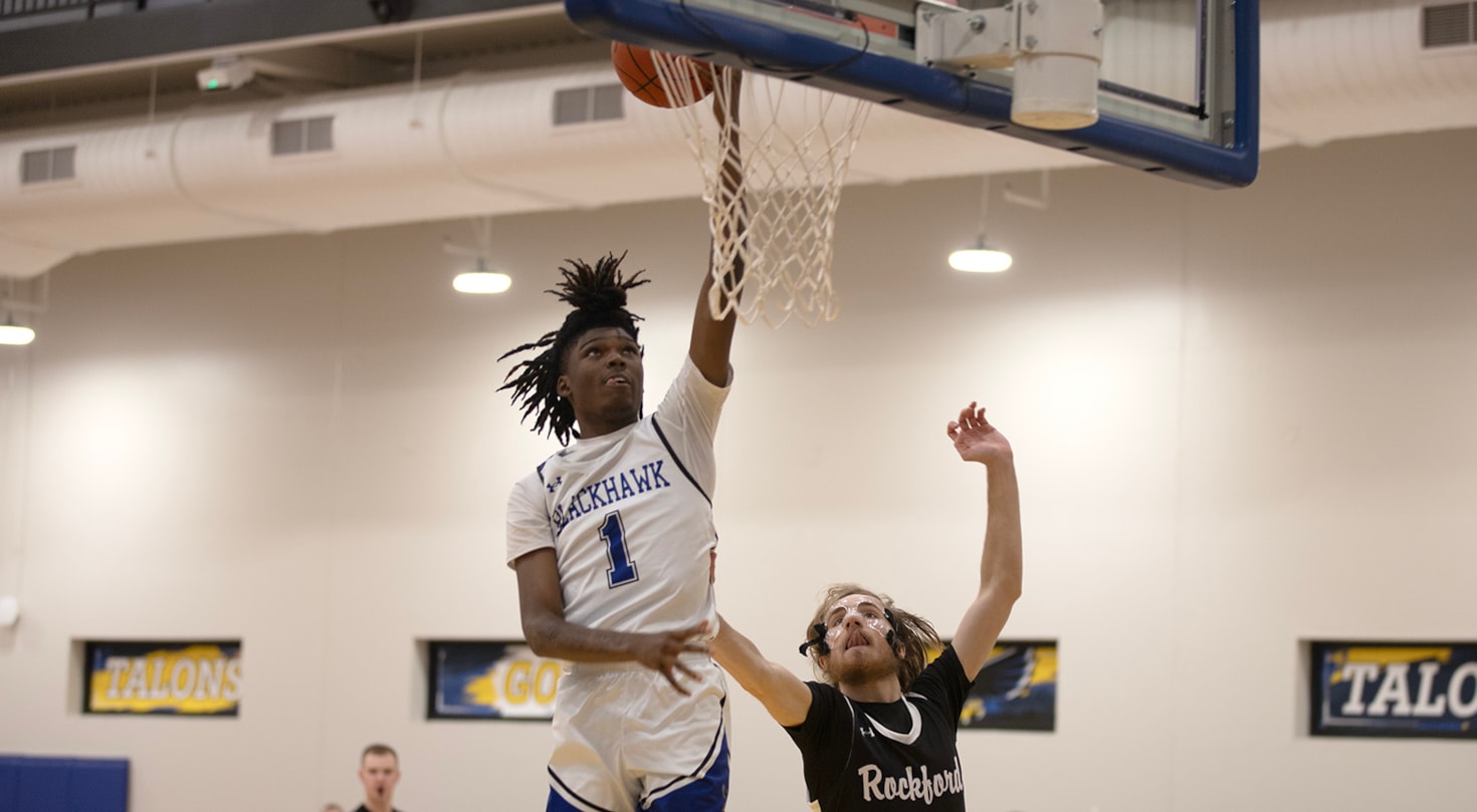 Blackhawk men's basketball player scoring against a defender